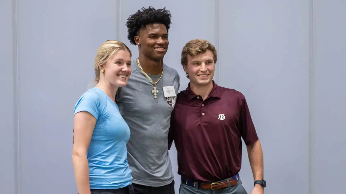 people giving thumbs up in stadium