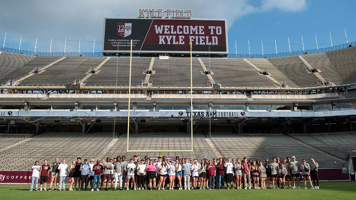 group photo in front of end zone