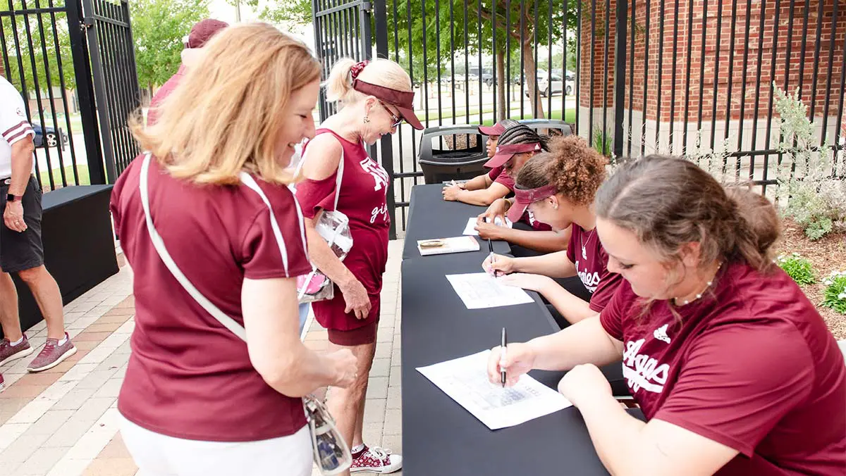 women filling out papers