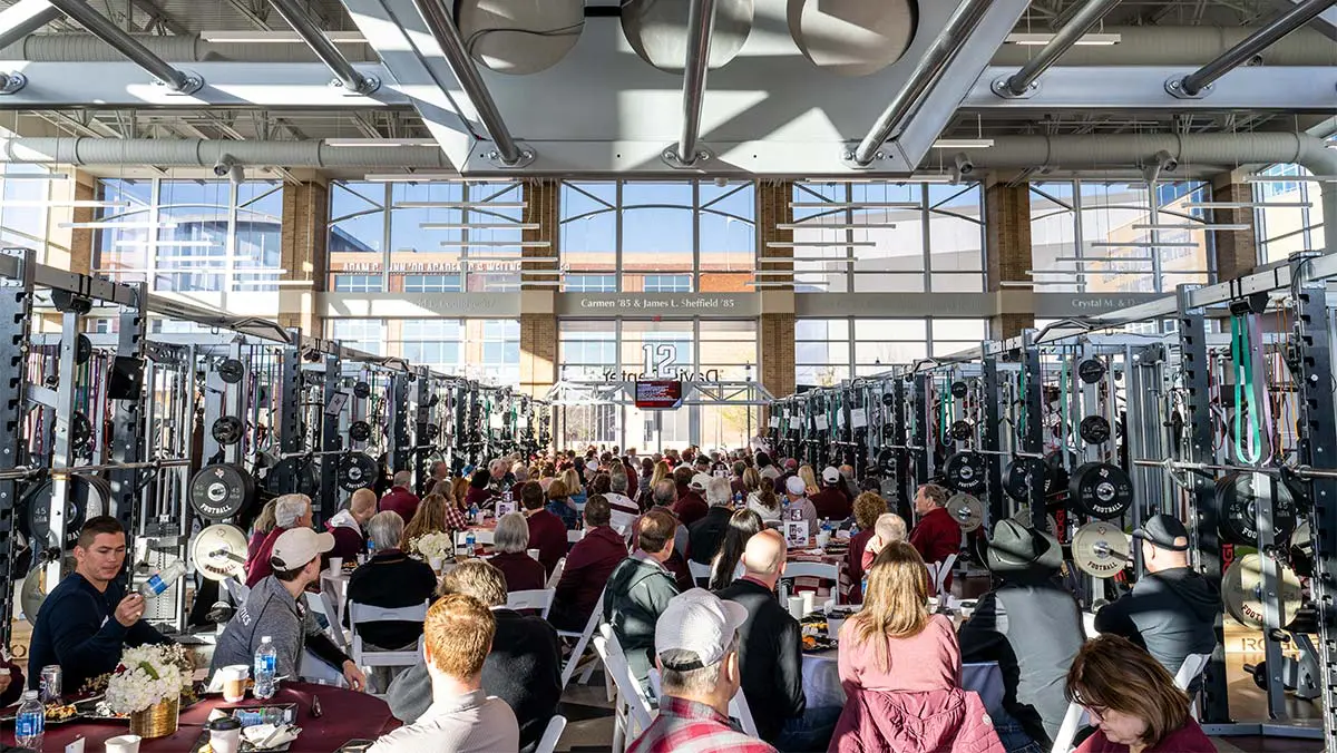 people at tables in the weight room