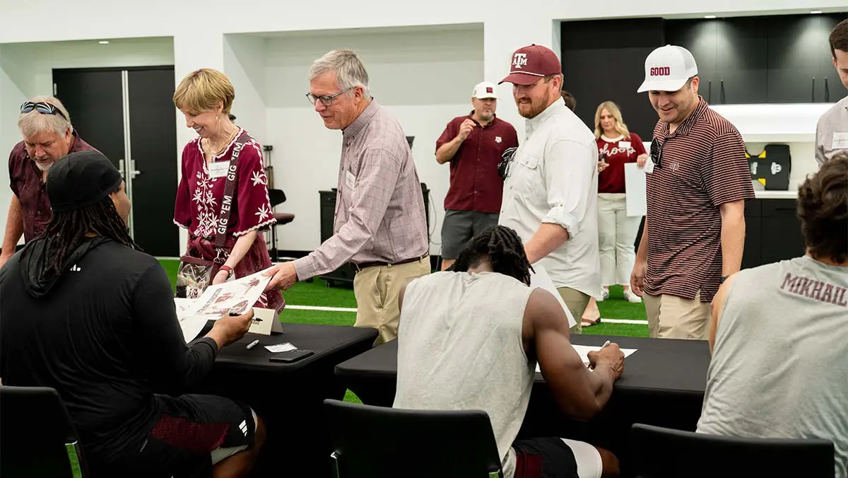 student-athletes signing autographs